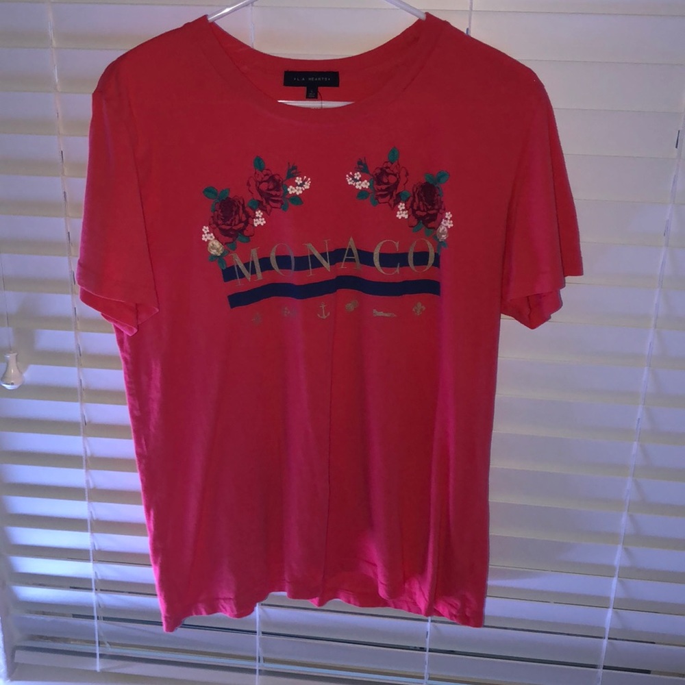 a reddish shirt with print on the front